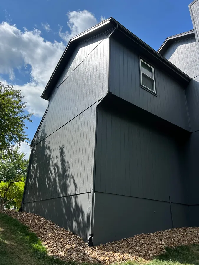 Charcoal board and batten siding with clean dark trim on a two-story home in Lenexa, Kansas