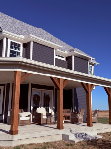 Navy board and batten siding with white trim on a Kansas City farmhouse porch