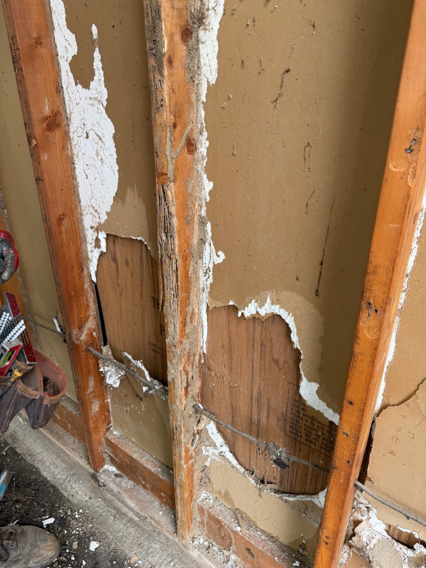 Interior wall opened up showing rotted studs and deteriorated sheathing from long-term moisture