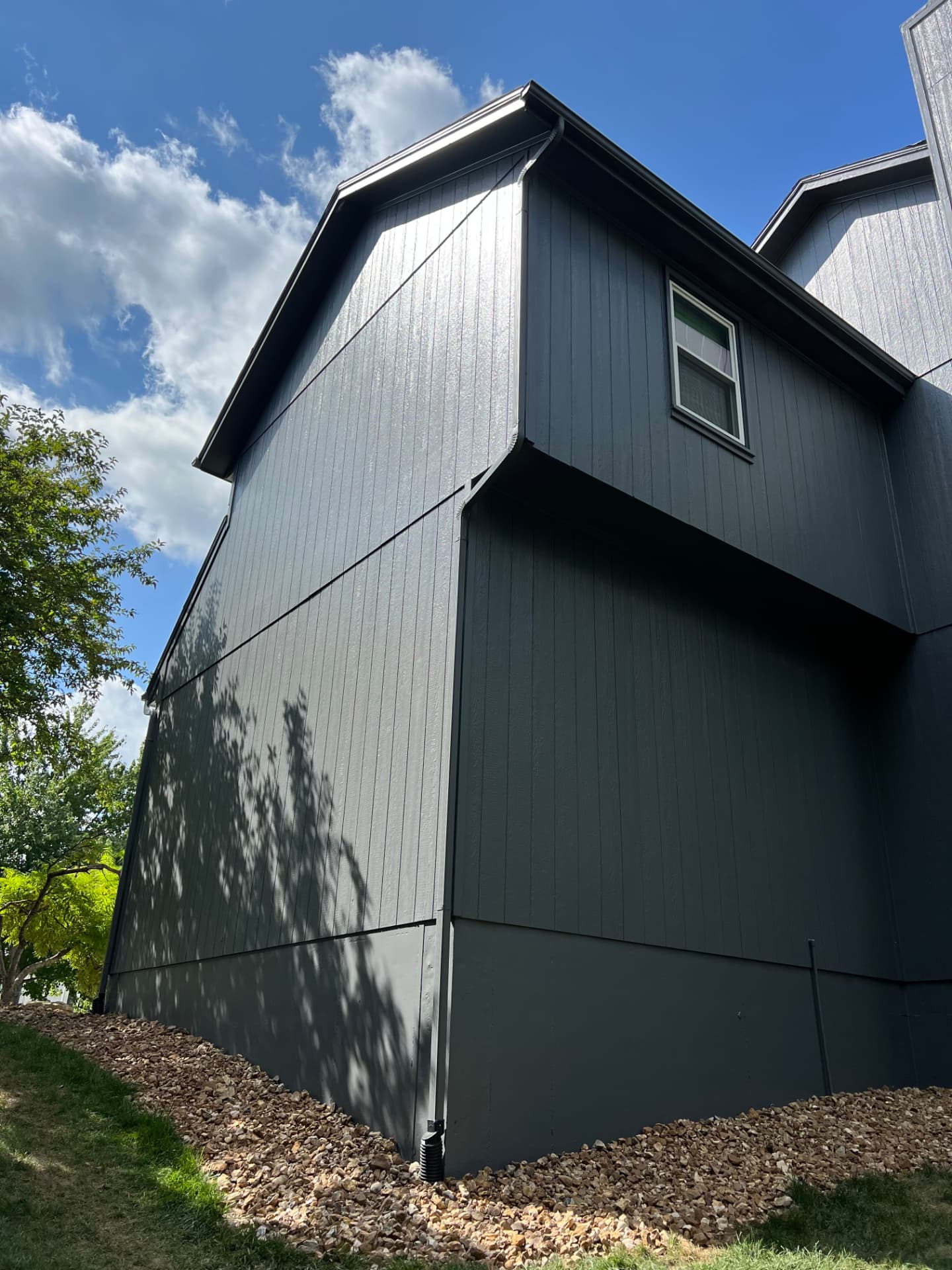 Charcoal board and batten siding with clean dark trim on a two-story Kansas City home